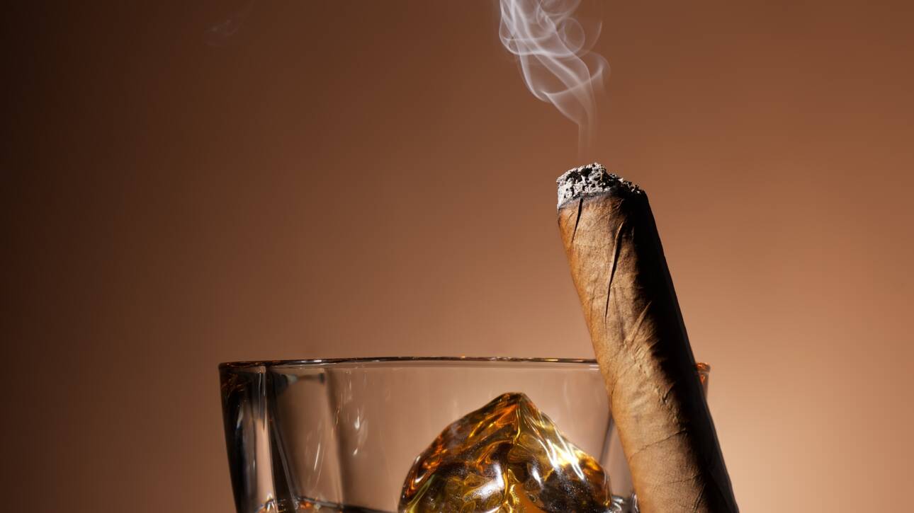 Glass,Of,Whiskey,And,Cigar,On,Brown,Background